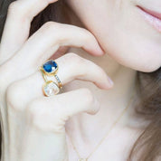 Model stylishly stacking the kyanite and clear quartz gold plated cushion bezel pave square stacking ring. . aqua chalcedony march birthday, march gemstone, white topaz, stacking ring, stackable, ring stack, square bezel set, bezel setting