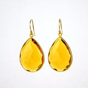 Large gold filled hook teardrop citrine gemstone earrings. November birthstone on white background
