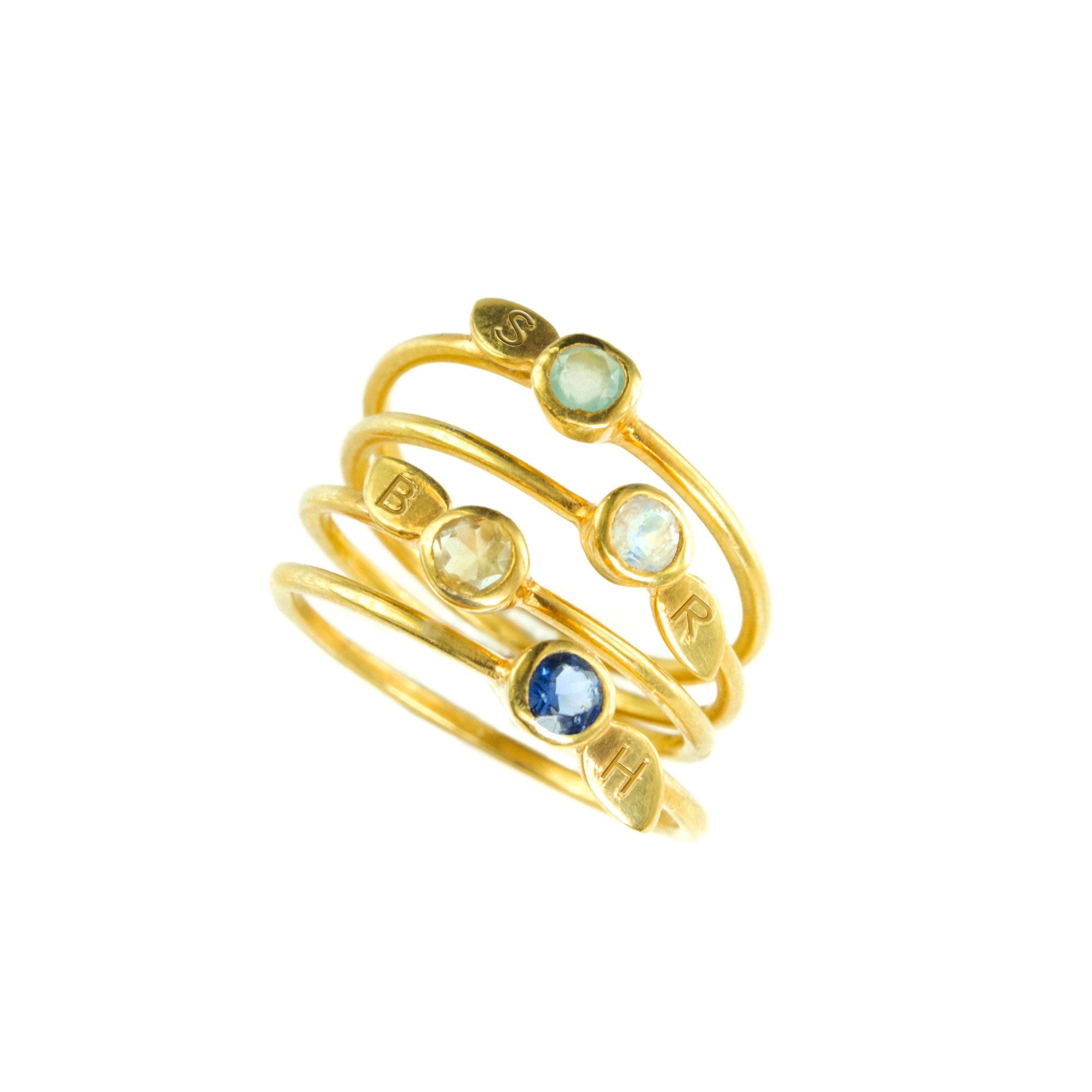 Collection of gold leaf initial 3 mm natural birthstone ring. Each ring can be engraved with one initial. 