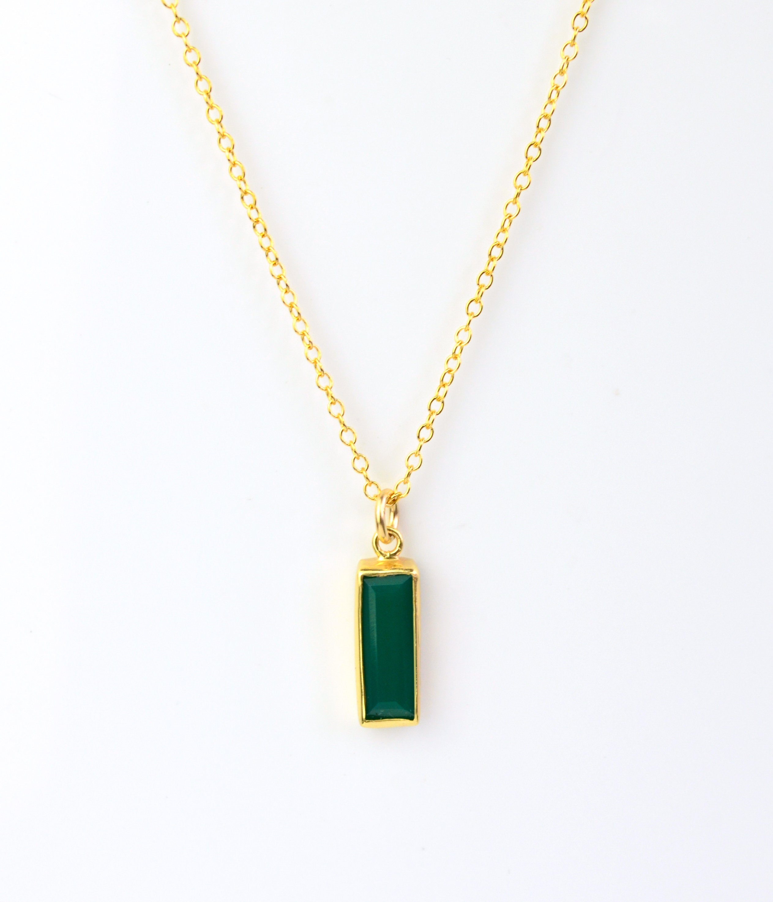 Single gold filled cable chain with green tourmaline may birthstone on white background