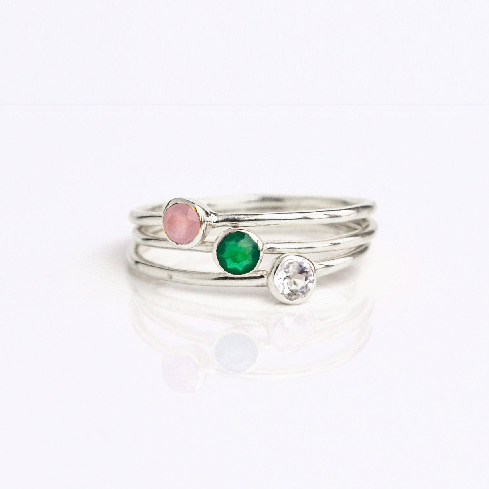 set of three sterling silver Single gold plated dainty 3mm gemstone rings featuring pink chalcedony, green onyx and clear quartz. October birthstone. On white background. 925 sterling silver, birthstone ring, stacking ring, stackable, birthstone jewelry, facet gemstone