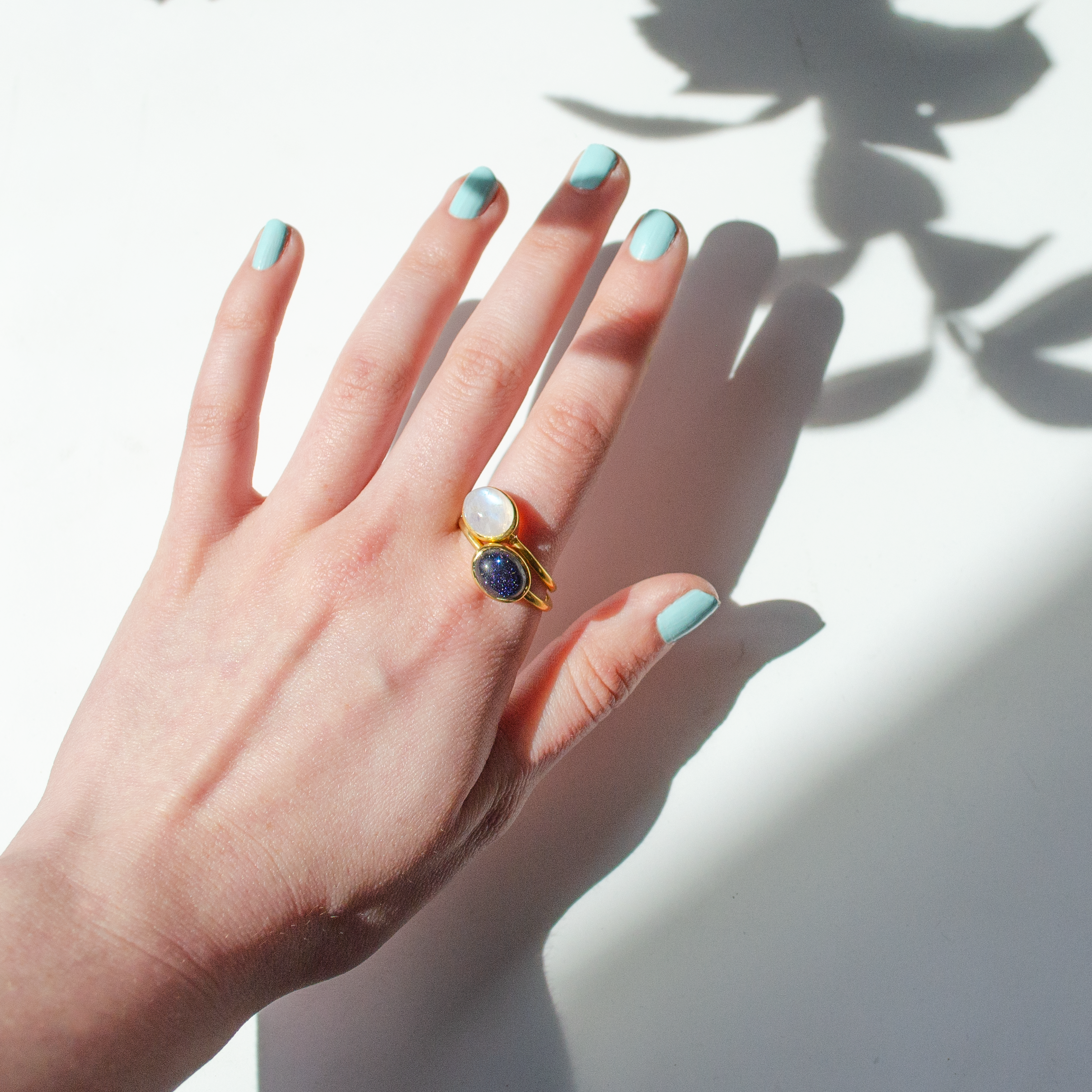 moonstone-goldstone-rings-on-hand_55824cc4-4169-48c6-88df-a9dffab7211d.png