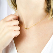 Model is wearing the dainty 3mm bar necklace in gold with black onyx
