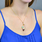 Model in blue top is wearing our Mothers four stone and engraved full name tag cascading diamond shape necklace with pink chalcedony, aqua chalcedony, moonstone, and purple amethyst. 