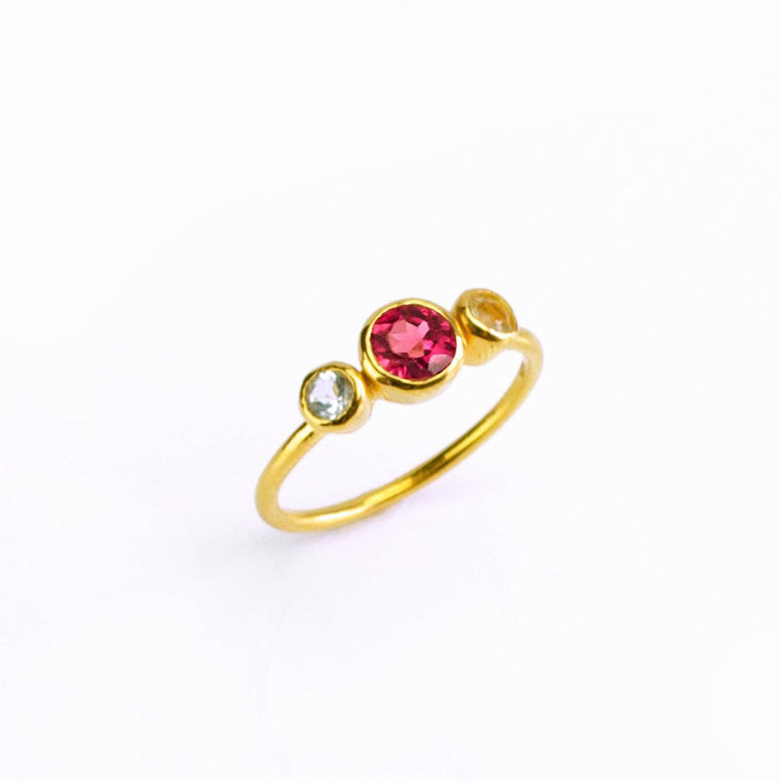 Single gold filled custom mothers and children birthstone ring with a 5mm garnet gemstone and clear and citrine 3mm birthstones for the kids. 