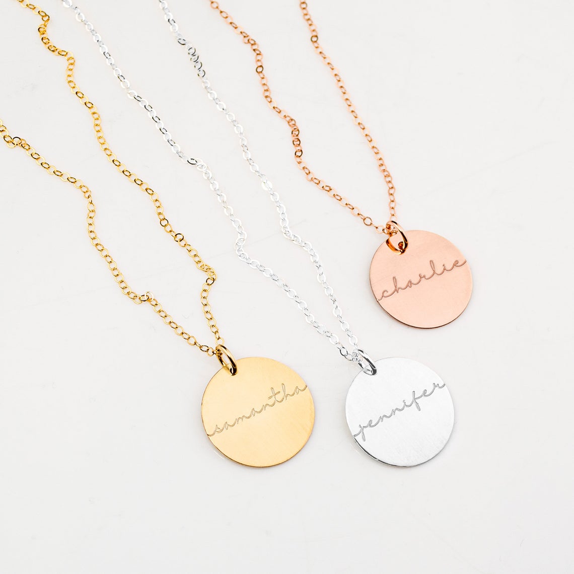 Custom engraved name disc pendant necklaces in gold, silver, and rose gold, personalized minimalist jewelry gift for her.