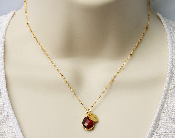 one-teardrop-bezel-initial-disk-gold.jpg