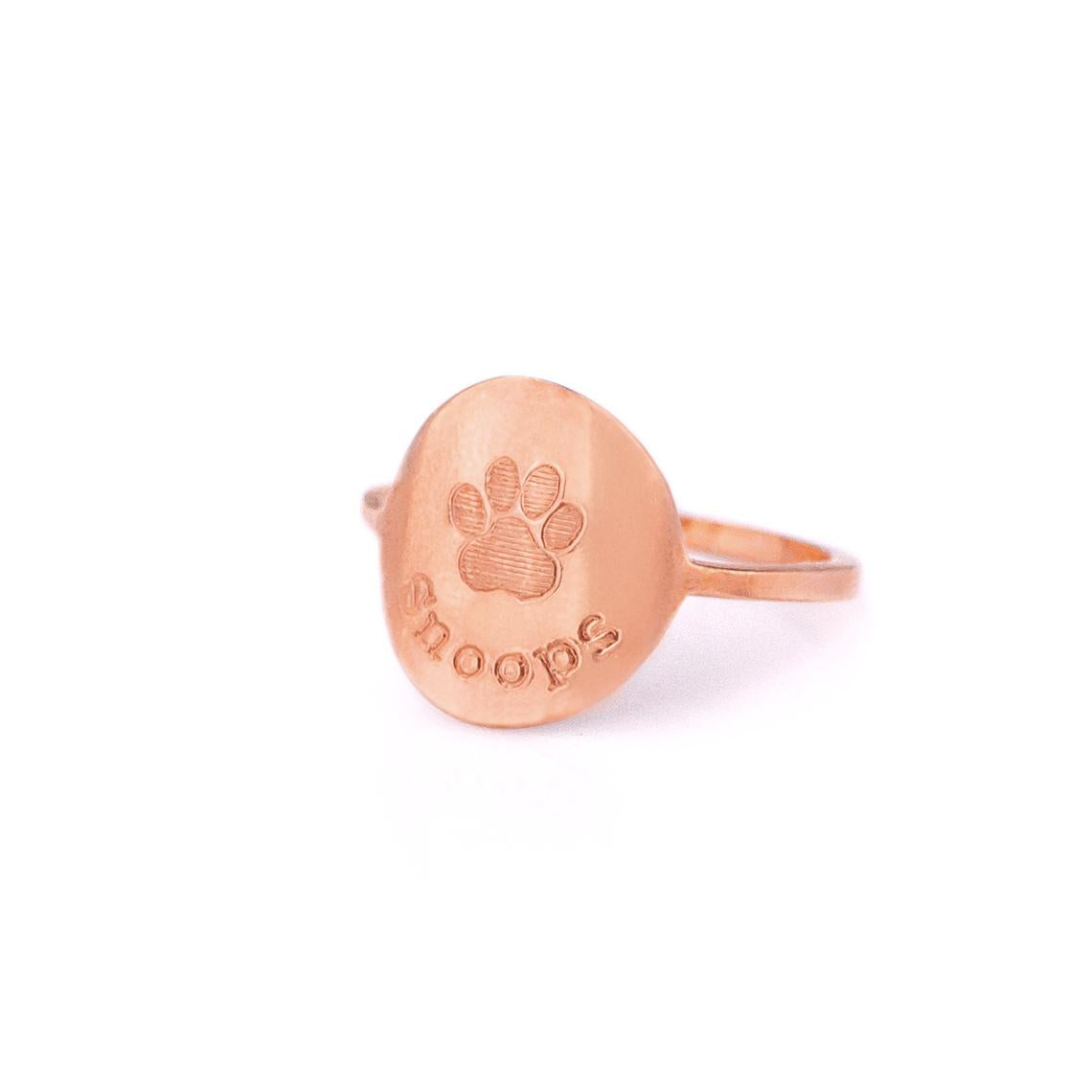 Rose gold custom engraved paw print ring with typewriter font and name Snoops.