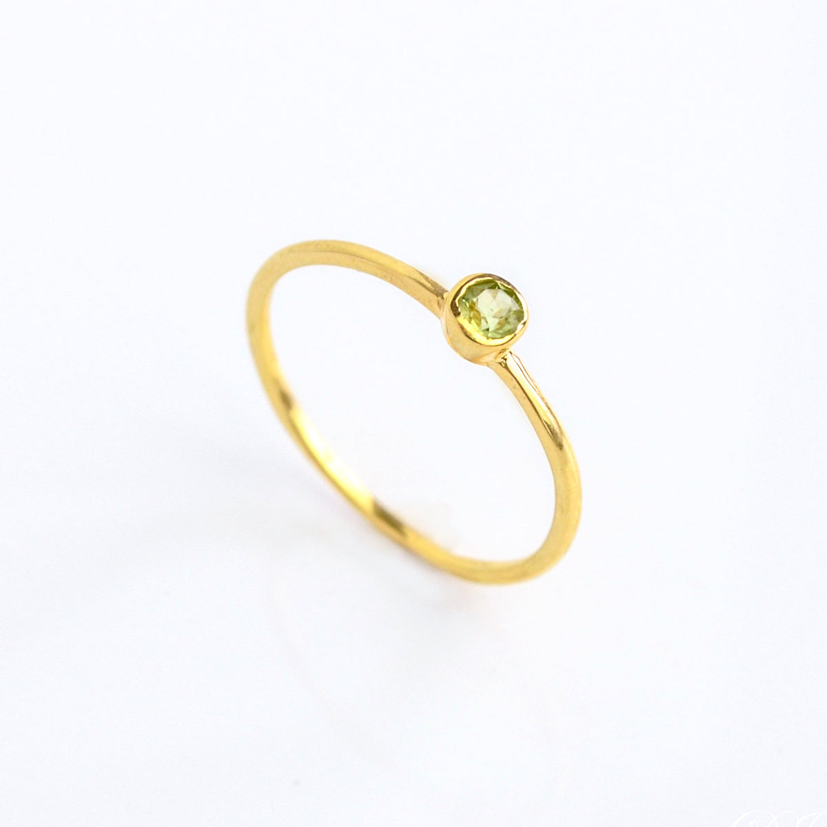 Single gold plated dainty 3mm peridot gemstone ring. august  birthstone. On white background. 925 sterling silver, birthstone ring, stacking ring, stackable, birthstone jewelry, facet gemstone