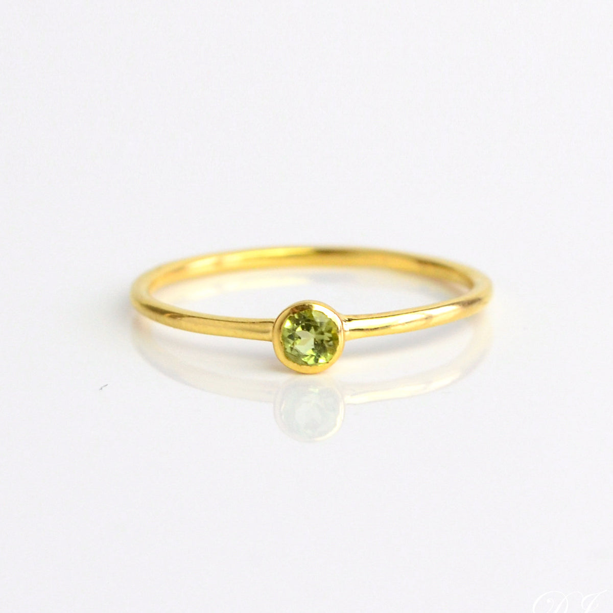 Single gold plated dainty 3mm peridot gemstone ring. august  birthstone. On white background. 925 sterling silver, birthstone ring, stacking ring, stackable, birthstone jewelry, facet gemstone