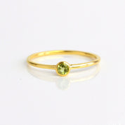 Single gold plated dainty 3mm peridot gemstone ring. august  birthstone. On white background. 925 sterling silver, birthstone ring, stacking ring, stackable, birthstone jewelry, facet gemstone