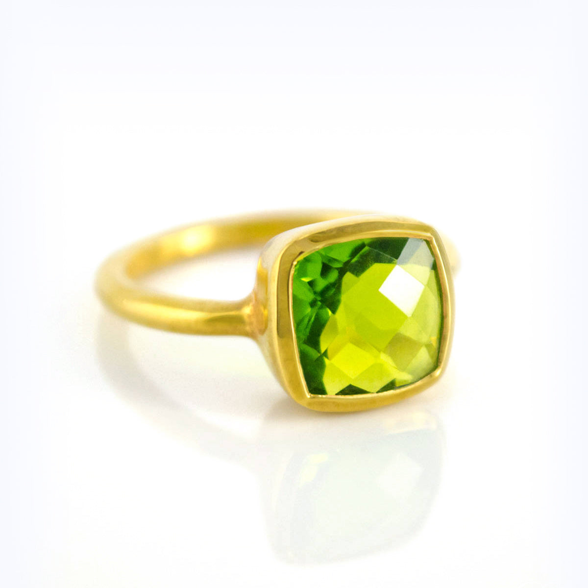 Peridot gold plated cushion bezel square stacking ring on white background. August birthday, august gemstone, square gemstone, green stone, green ring, august birthstone, sterling silver ring
