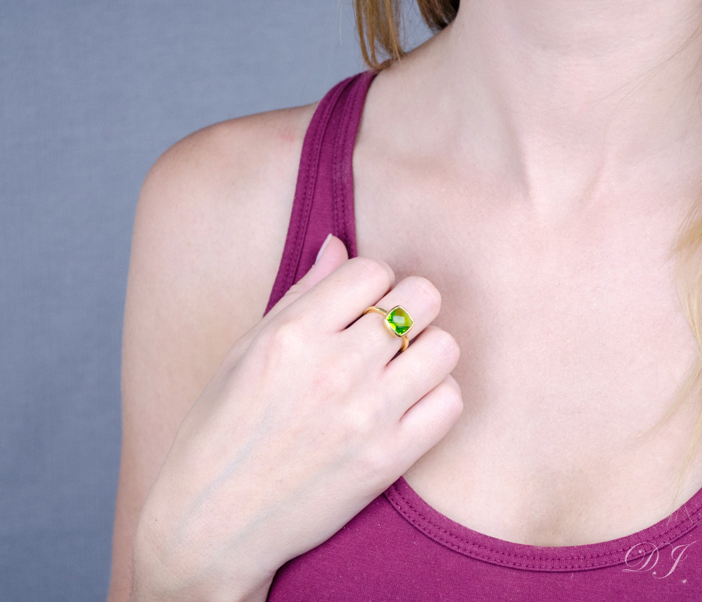 model wearing Peridot gold plated cushion bezel square stacking ring 
