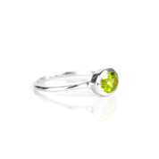 a sterling silver peridot ring shown on white background. stackable! Stacking rings, bezel set, small oval, tiny oval, dainty oval, birthstone rings, sterling silver stamp, birthstone ring, birthstone jewelry, green gemstone, peridot birthstone, august birthstone, august gemstone