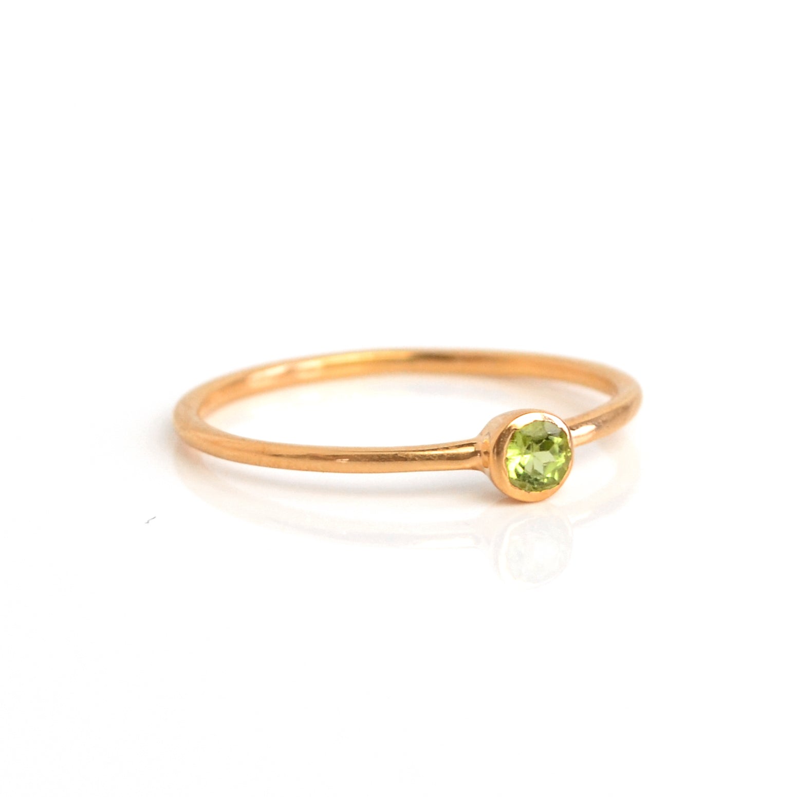 Rose gold plated dainty 3mm peridot gemstone ring. august  birthstone. On white background. 925 sterling silver, birthstone ring, stacking ring, stackable, birthstone jewelry, facet gemstone