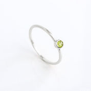 sterling silver Single dainty 3mm peridot gemstone ring. august  birthstone. On white background. 925 sterling silver, birthstone ring, stacking ring, stackable, birthstone jewelry, facet gemstone