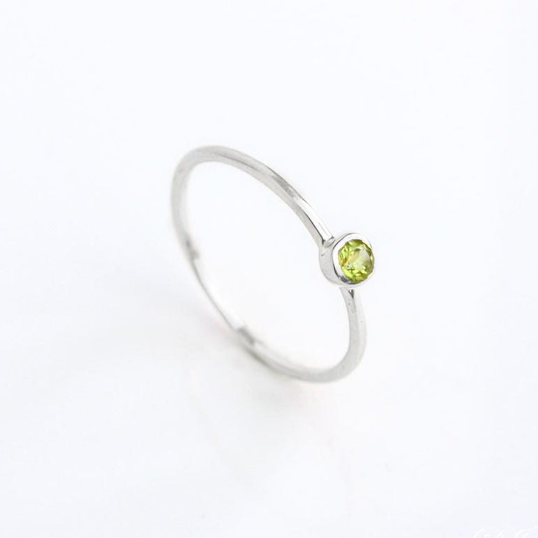 sterling silver Single dainty 3mm peridot gemstone ring. august  birthstone. On white background. 925 sterling silver, birthstone ring, stacking ring, stackable, birthstone jewelry, facet gemstone