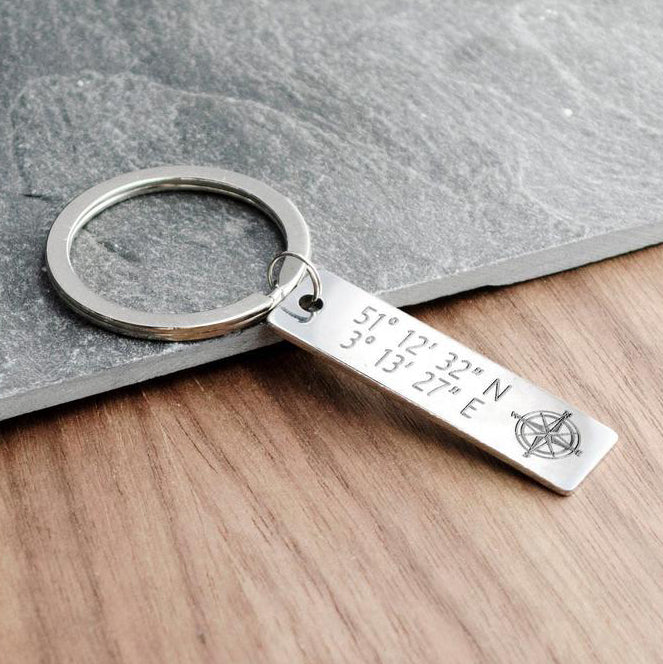 Single silver skinny rectangle keychain with special memorable coordinates engraved with a compass symbol.
