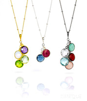 Three satellite chain necklaces. First in gold with purple amethyst, moonstone, green amethyst and peridot birthstones. Middle necklace features garnet and kyanite stones in sterling silver. Last necklace is oxidized silver with aqua chalcedony, clear, garnet, sky blue quartz and pink chalcedony birthstones
