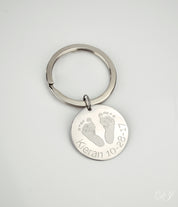 Single footprint keychain engraved in block font with baby's name and birth date. 