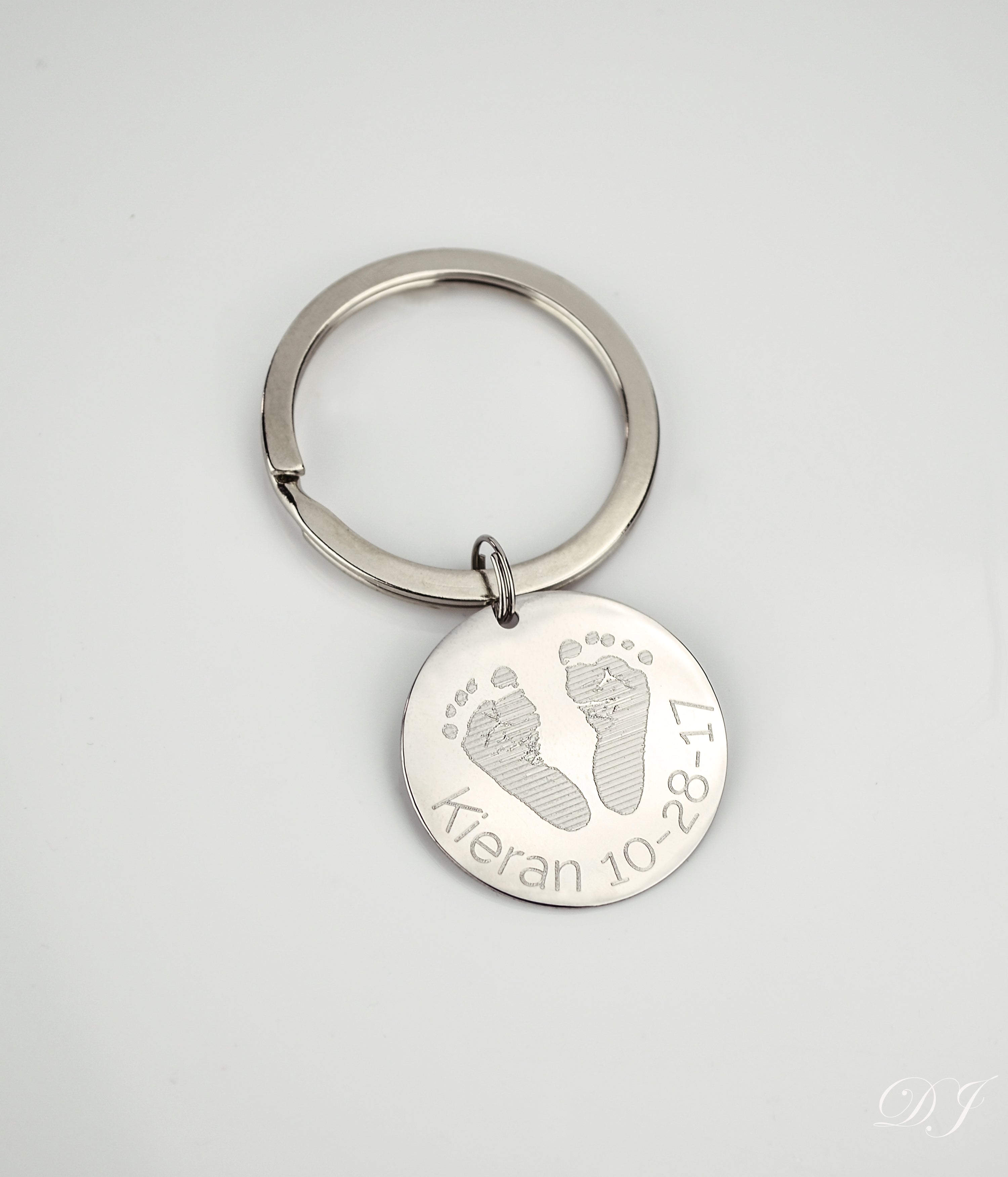 Single footprint keychain engraved in block font with baby's name and birth date. 
