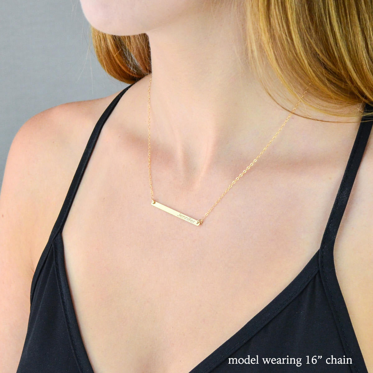 Skinny Bar Necklace Personalized with name engraving and a heart worn by model on a 16 in gold filled cable chain