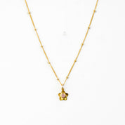 Single small flower bloom pink chalcedony birthstone necklace on a gold filled satellite chain with a white background. 