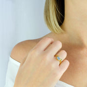 Model wearing the labradorite and green amethyst stacking small rings in gold 