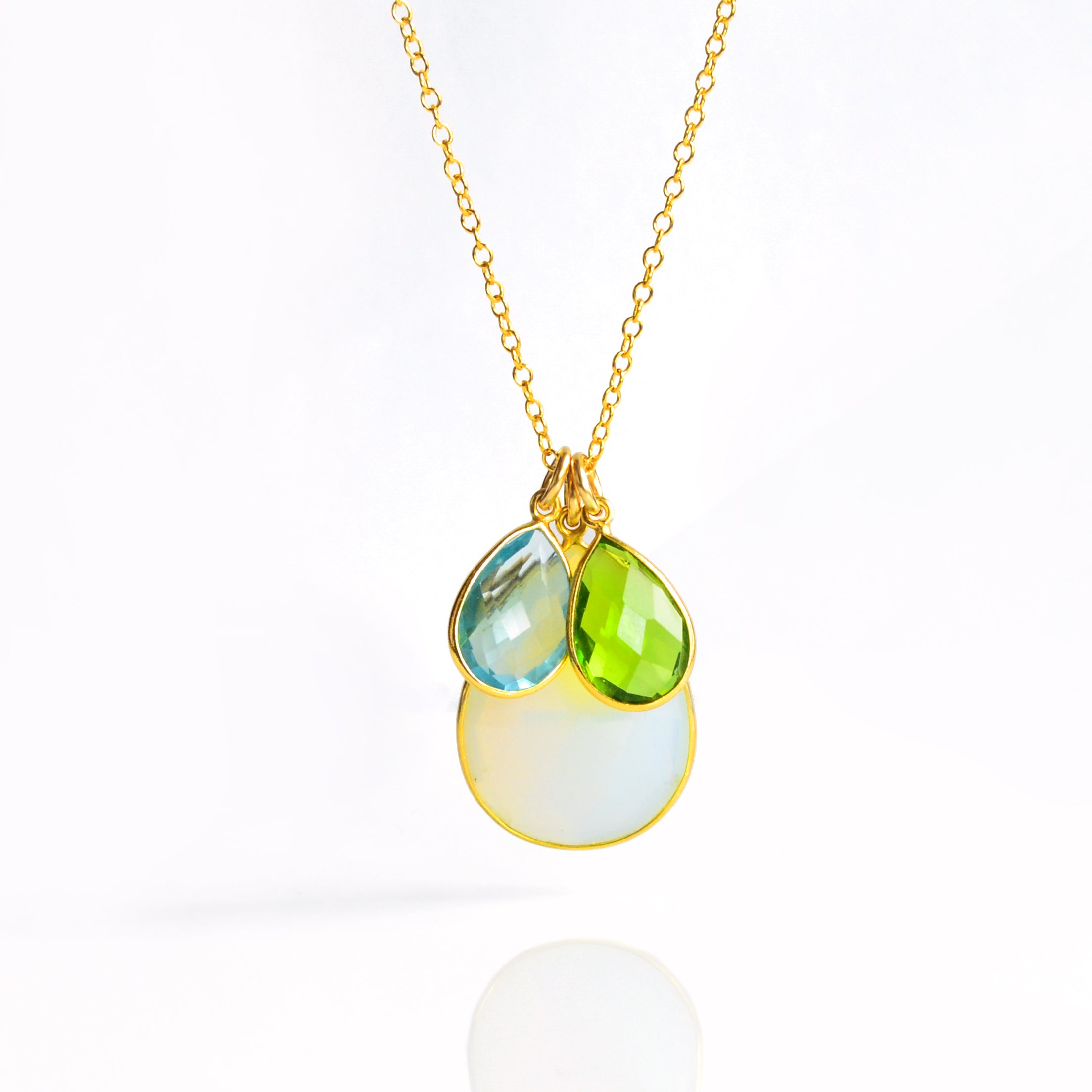 Single gold filled cable chain with mothers moonstone, peridot and sky blue children's birthstones on white background.