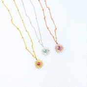 Dainty sunburst birthstone necklaces displayed in gold filled, sterling silver, and rose gold filled finishes, each featuring a sparkling center birthstone in a radiant sun design. Personalized minimalist jewelry perfect for everyday wear or gifting, available with all twelve birthstones for birthdays, Mother’s Day, Christmas, bridesmaids or best friend gifts. Ideal sentimental necklace for stacking or layering.