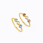 Two Triple Birthstone Rings in Vermeil Gold on a white background. Personalized Birthstone Rings for Mom of three, Perfect gift for Mother's Day. December Birthstone, November Birthstone, and September Birthstone Dainty Bezel Set Ring. January Birthstone, June Birthstone, and February Birthstone Custom Ring with Kids Birthstones. Blue Topaz, Citrine and Kyanite Ring. Garnet, Rainbow Moonstone, and Purple Amethyst Ring