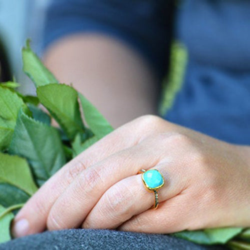 Model in blue top is wearing a Gold plated Turquoise ring with topaz accents, december birthstone jewelry, blue gemstone ring, square cushion faceted turquoise, Bezel set ring, Sterling silver ring, turquoise gift, december birthday gift, turquoise ring for her